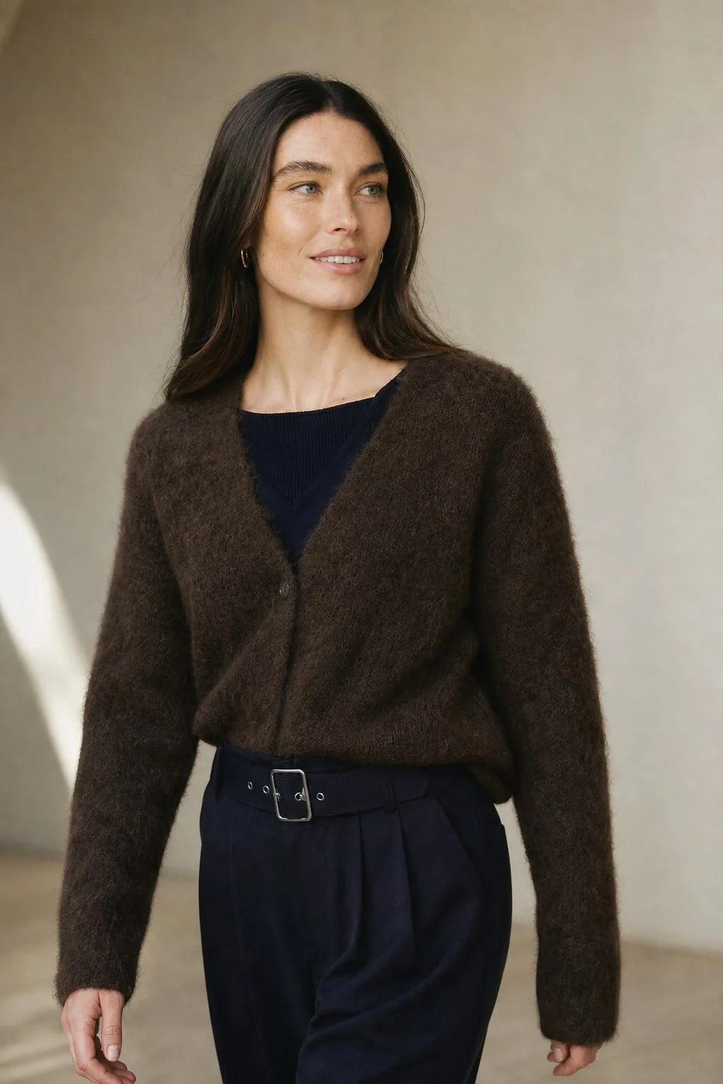Side angle of fluffy cashmere cardigan highlighting soft texture and drape