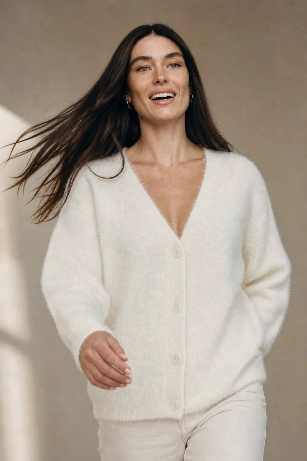 Close-up view of fluffy cashmere cardigan texture showing soft plush finish and V-neckline detail