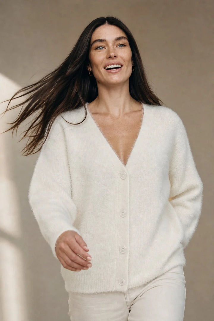 Close-up view of fluffy cashmere cardigan texture showing soft plush finish and V-neckline detail