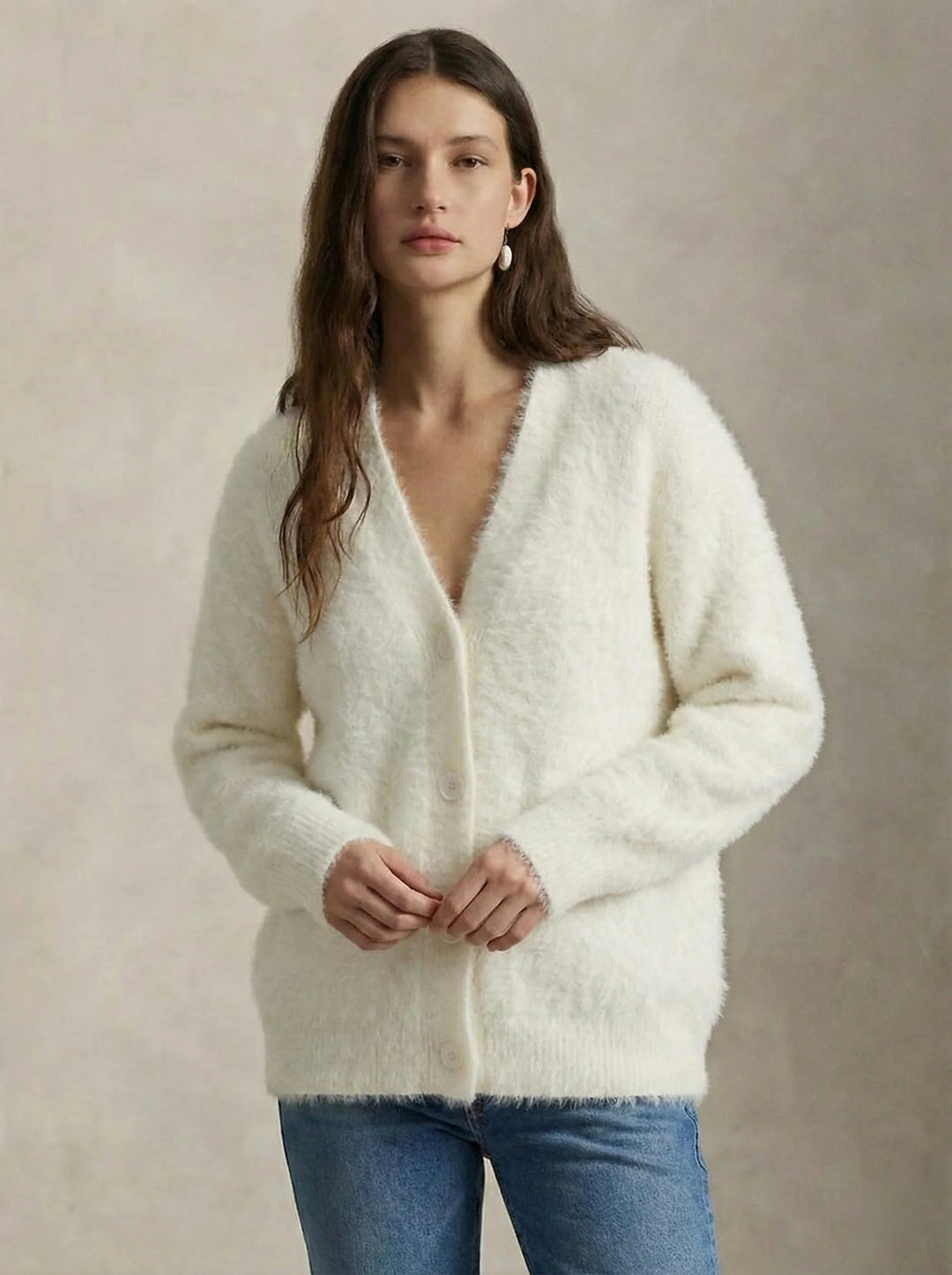 Woman layering cashmere cardigan for casual home comfort and style