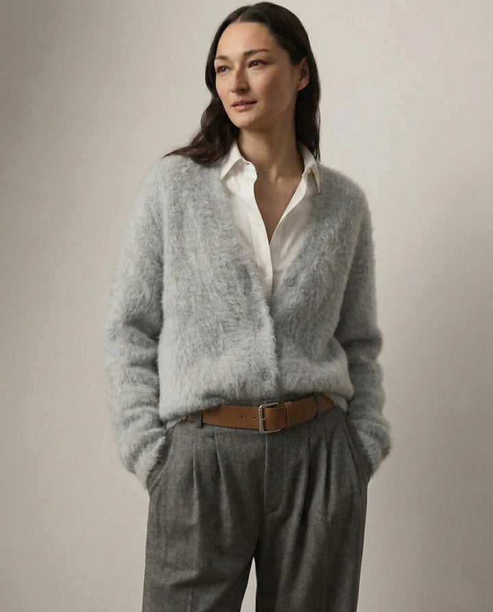 Woman styling cashmere cardigan with neutral trousers for effortless look
