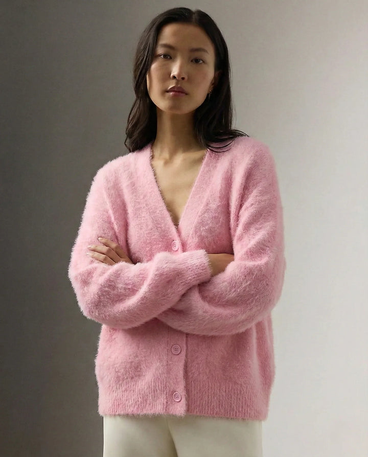 Side profile showing drape and fit of oversized cashmere cardigan