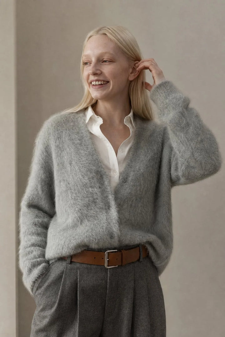 Side profile of oversized cashmere cardigan with dropped shoulders and ribbed cuffs on model