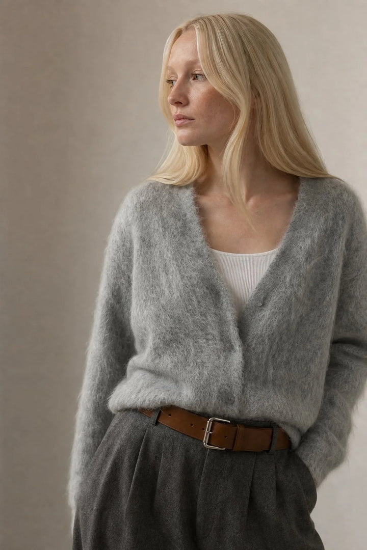 Woman styling cream cashmere cardigan with neutral trousers for a relaxed casual outfit