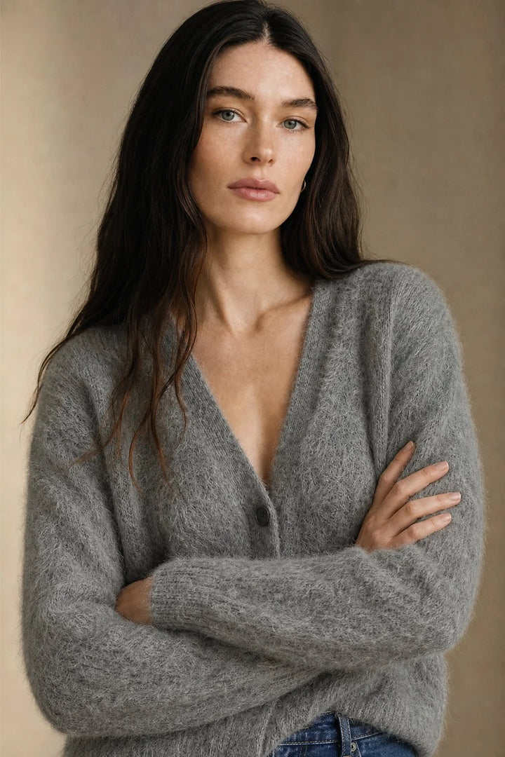 Full-length view of women's cashmere cardigan paired with high-waist trousers