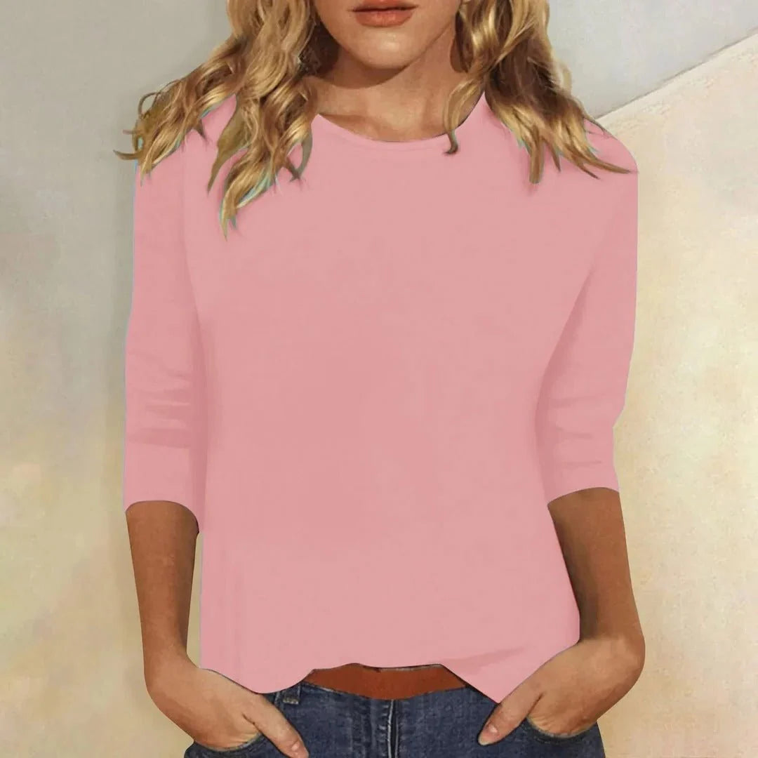 Women's crew neck top in pink with three quarter sleeves and relaxed fit worn with denim