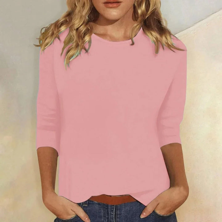 Women's crew neck top in pink with three quarter sleeves and relaxed fit worn with denim