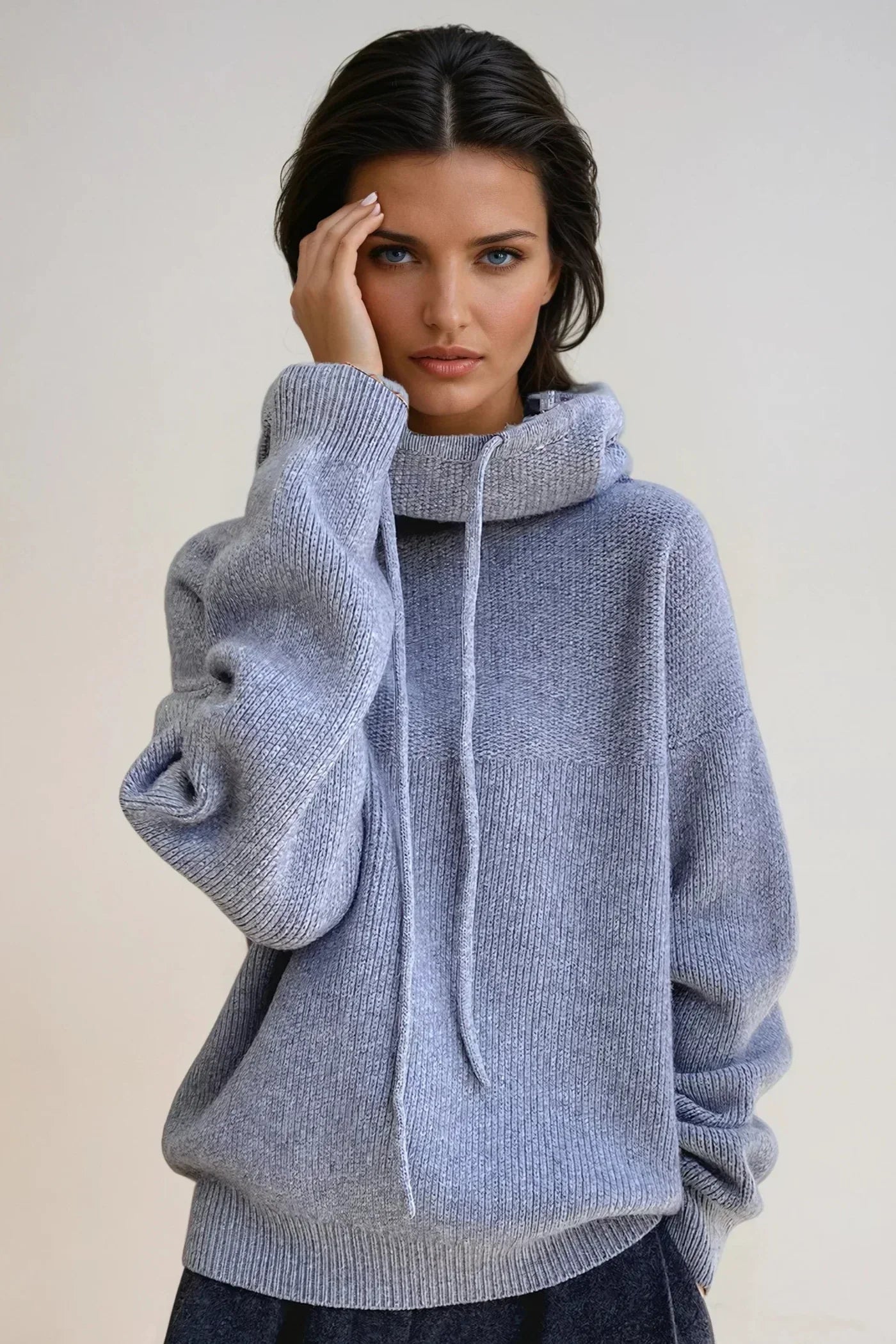 Full-length view of women's relaxed-fit hooded jumper paired with high-waisted bottoms