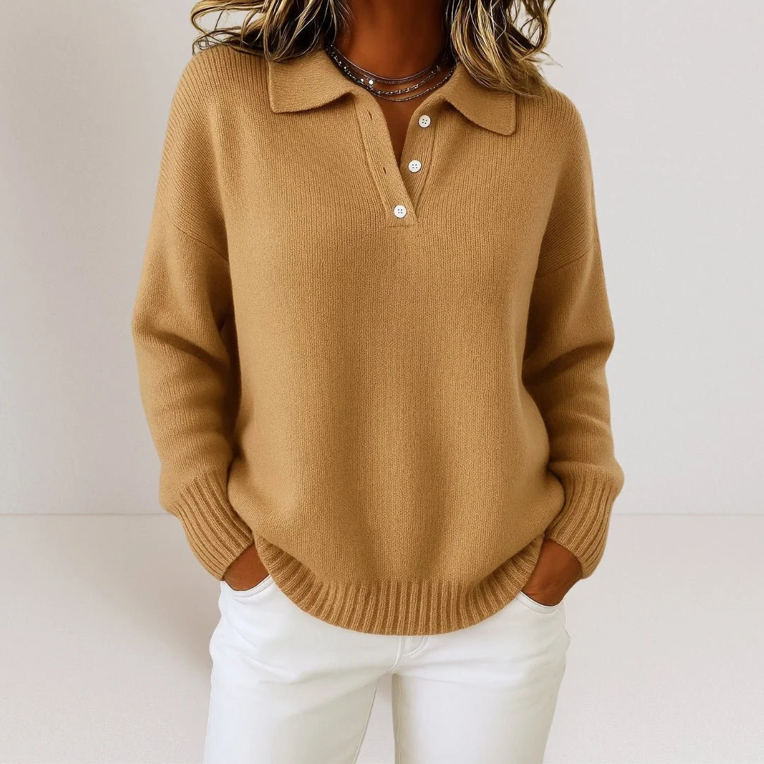 Women's polo jumper styled with white trousers for a casual preppy look