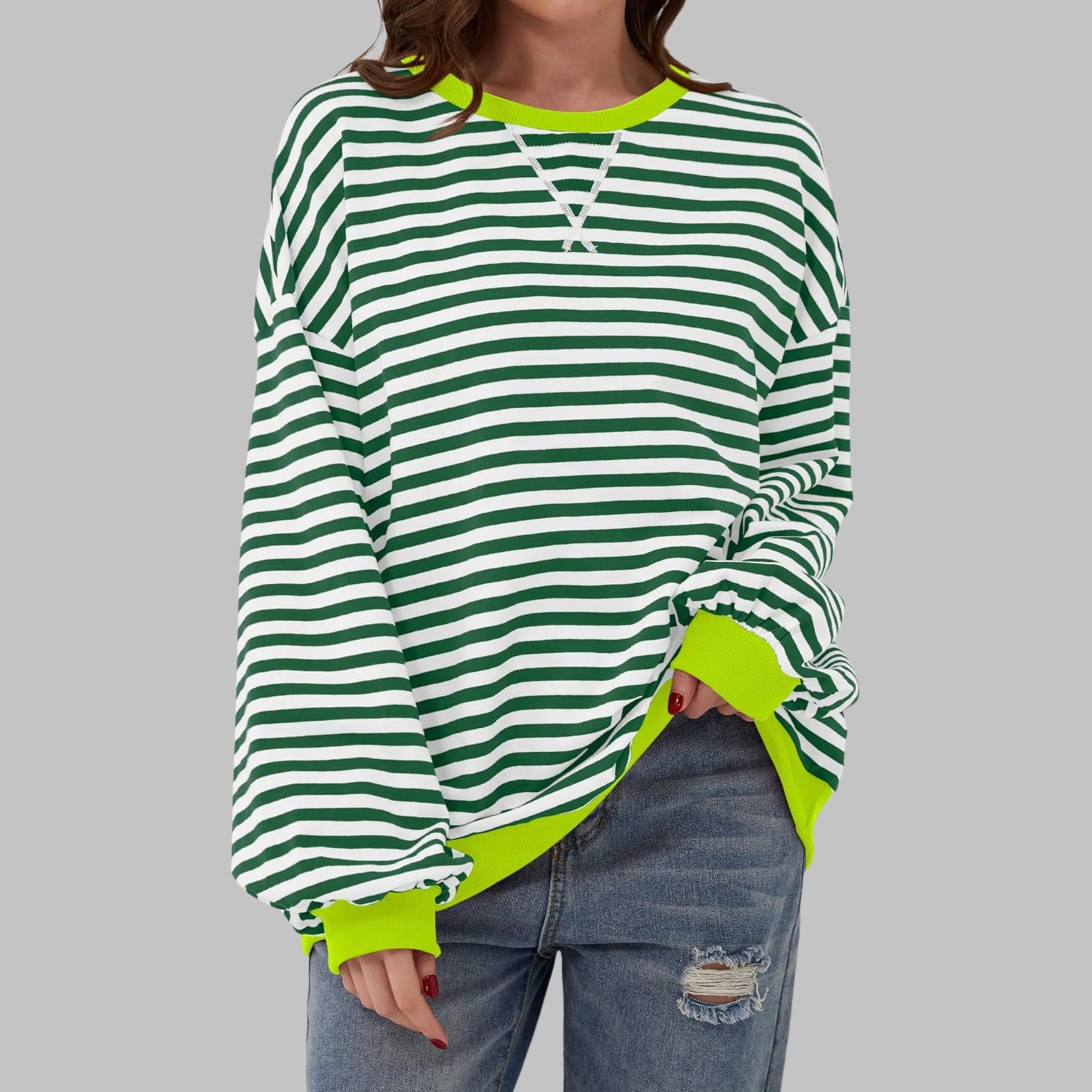 Women's striped crew neck jumper styled for casual weekend wear with jeans