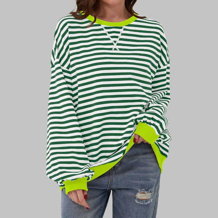 Women's striped crew neck jumper styled for casual weekend wear with jeans