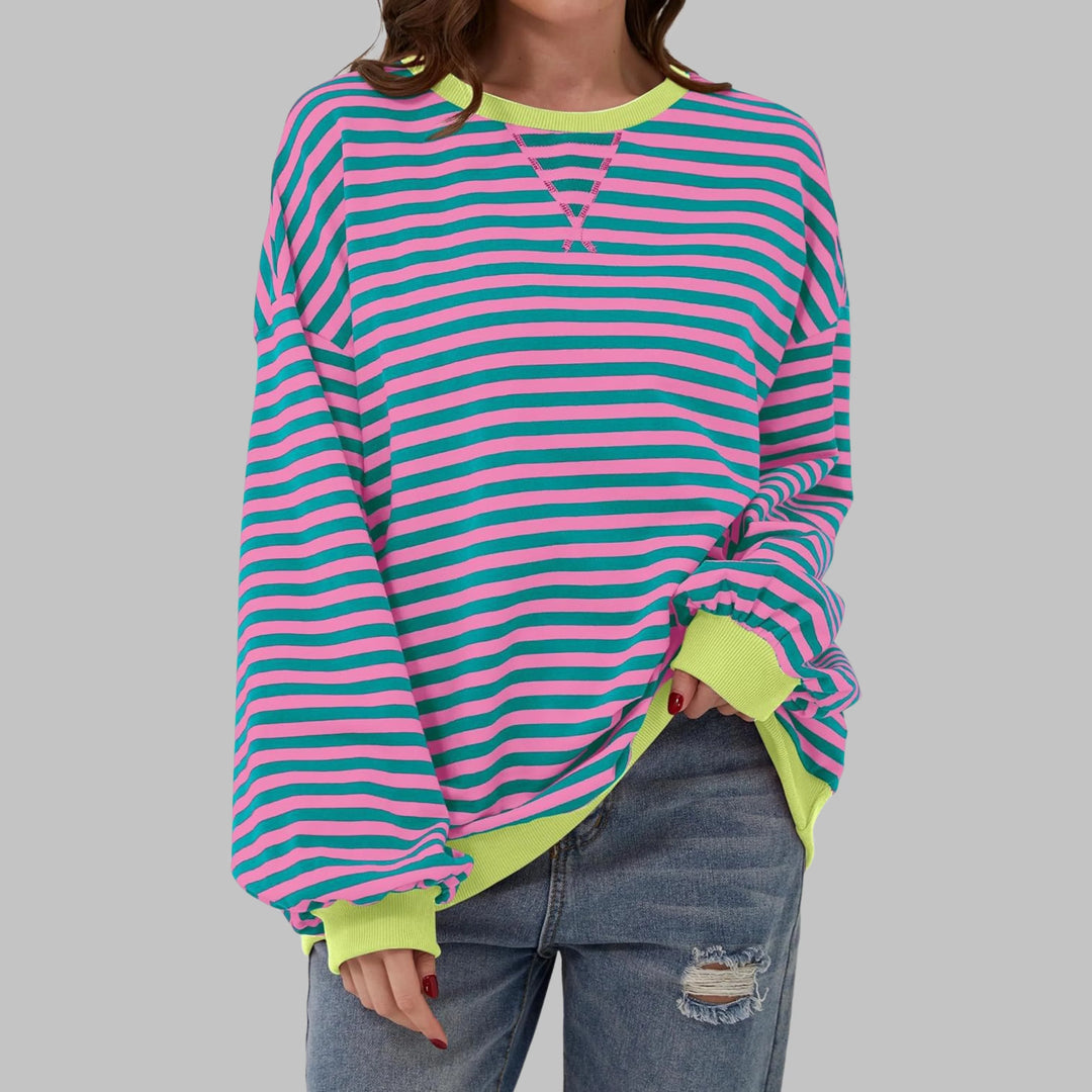 Side view of women's striped pullover jumper with ribbed hem and oversized silhouette