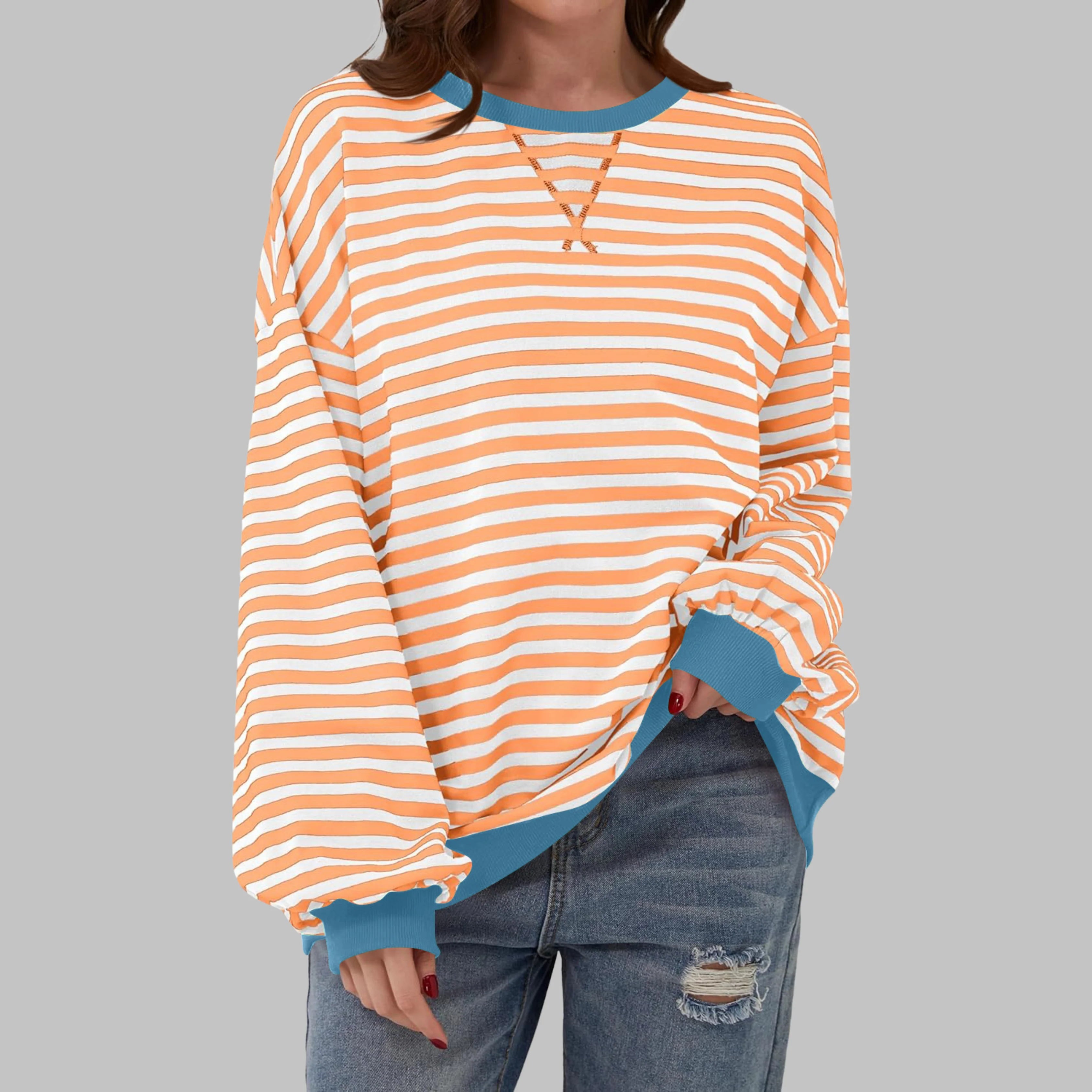 Detail of contrasting ribbed cuffs on women's oversized striped jumper