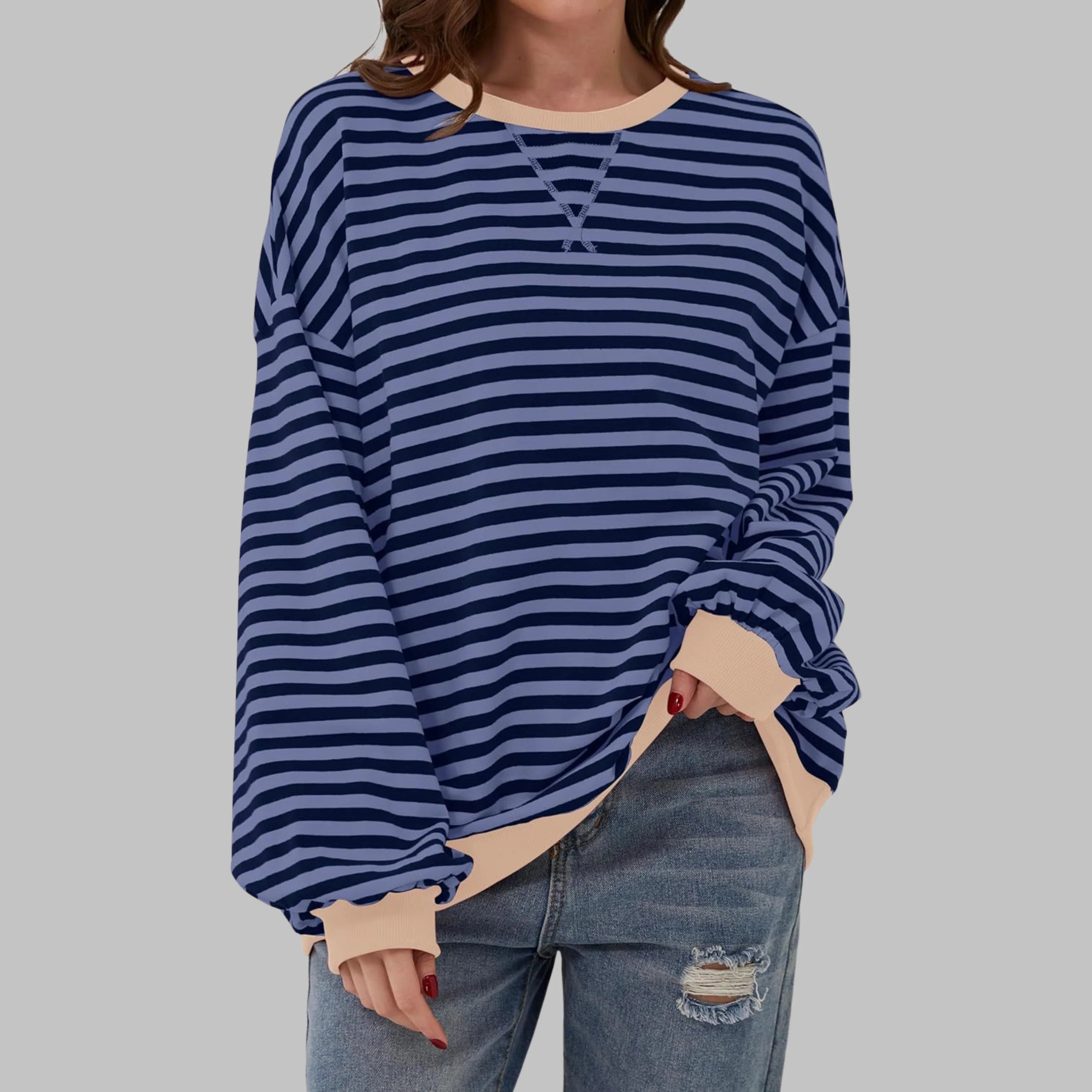 Back view of oversized striped pullover showing relaxed drape and ribbed hem