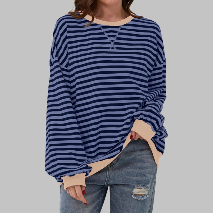 Back view of oversized striped pullover showing relaxed drape and ribbed hem